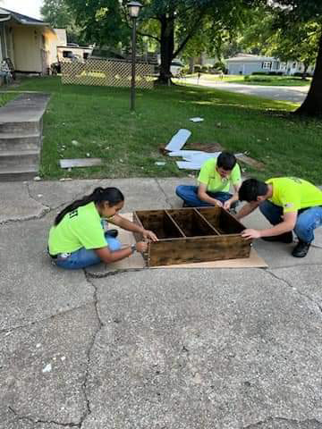 sheperd's center kansas city kansas volunteers fixing shelf